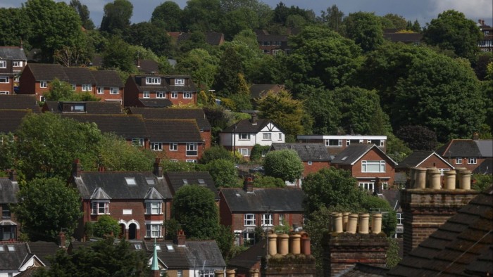 A view of residential properties in Chesham, UK, surrounded by lush greenery and trees