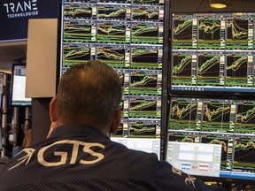 A specialist studies monitors on the New York Stock Exchange trading floor in New York on November 21, 2024.